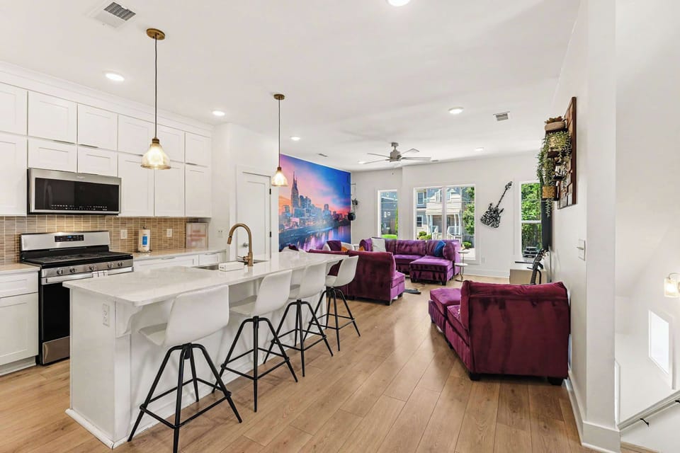 The gleaming, modern kitchen offers ample space & all the comforts of home