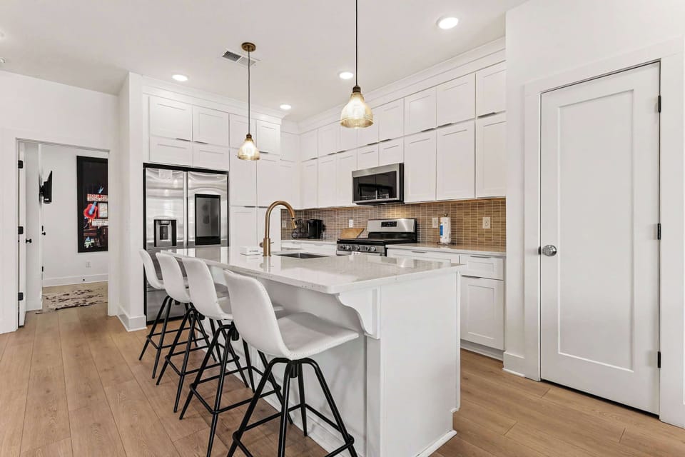 The gleaming, modern kitchen offers ample space & all the comforts of home
