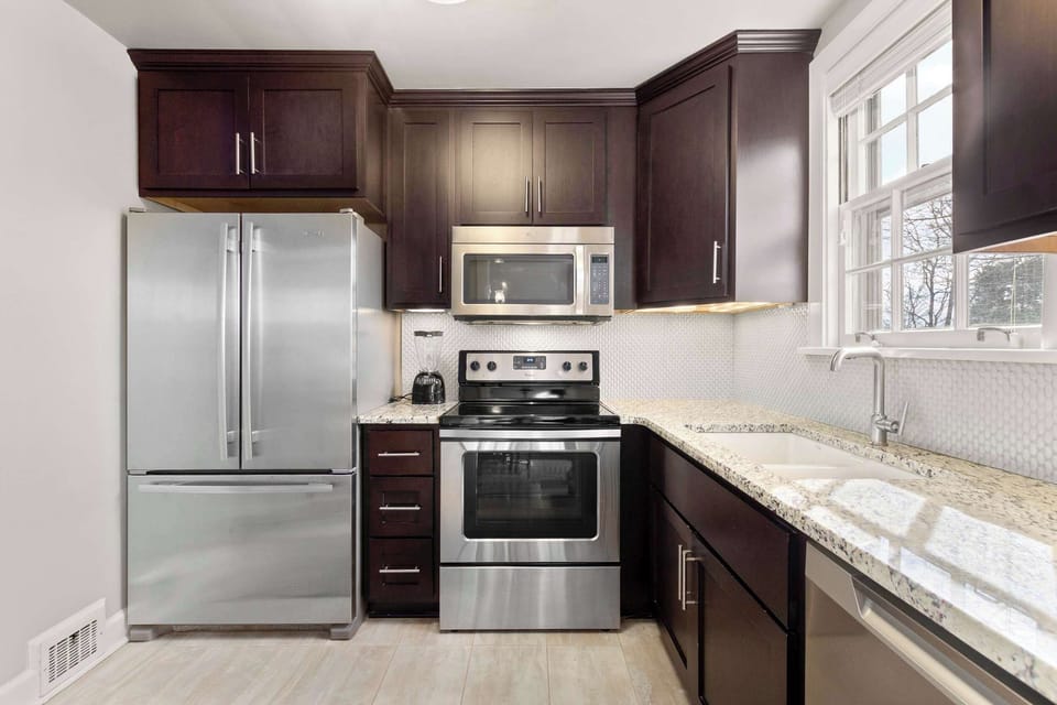 Full kitchen with dishwasher, blender, and standard drip coffee maker