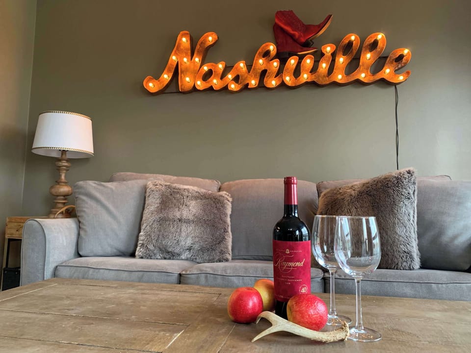 Living room with sofa sleeper, Smart TV, and balcony