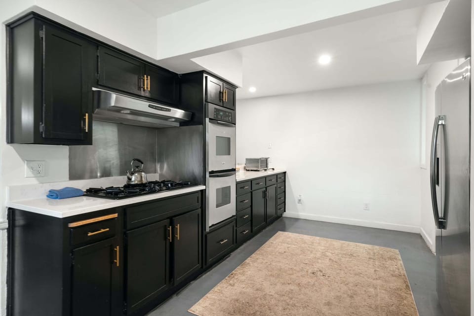 The sleek kitchen offers ample space & all the comforts of home