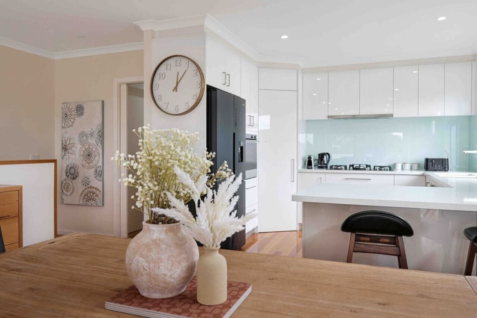 Spacious kitchen and dining space with breakfast bar and sleek design