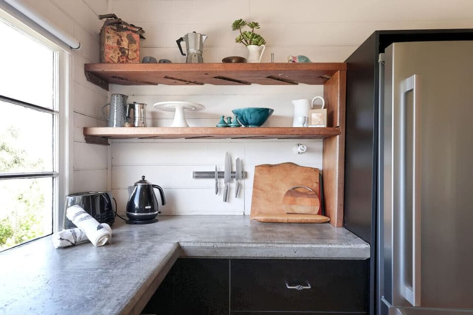 Functional kitchen corner with open shelves and prep space