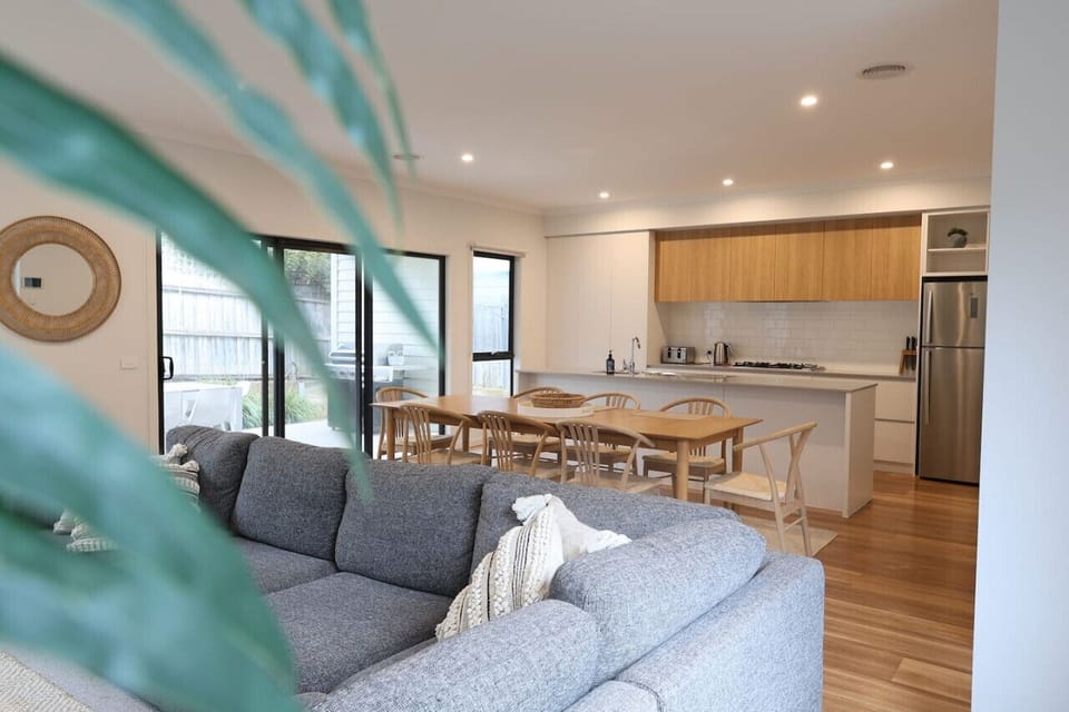 Open-plan living and dining area with modern kitchen and cozy seating