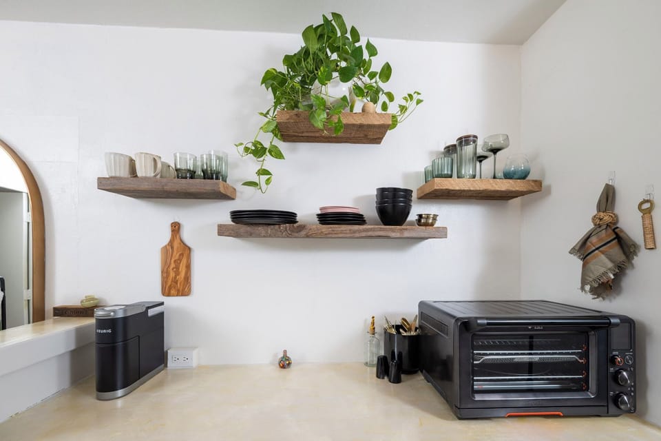 A minimalist kitchenette that makes the most of its space, featuring all the essentials for light meals and coffee breaks.
