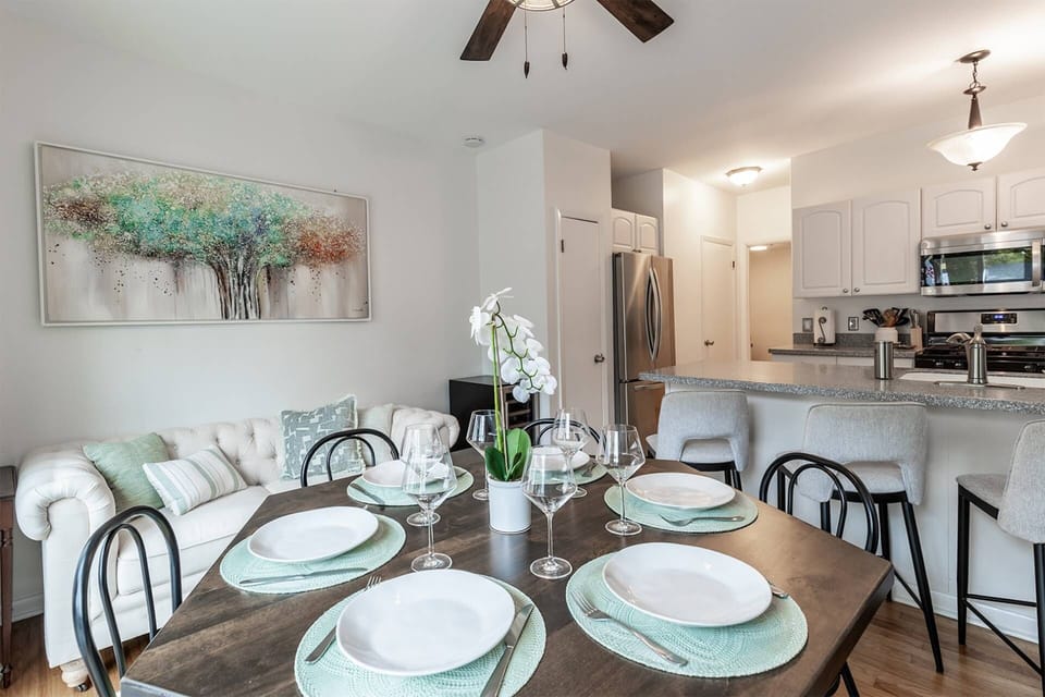 The open kitchen and dining area seats up to 10 people at the table and breakfast bar with overflow on the sofa.