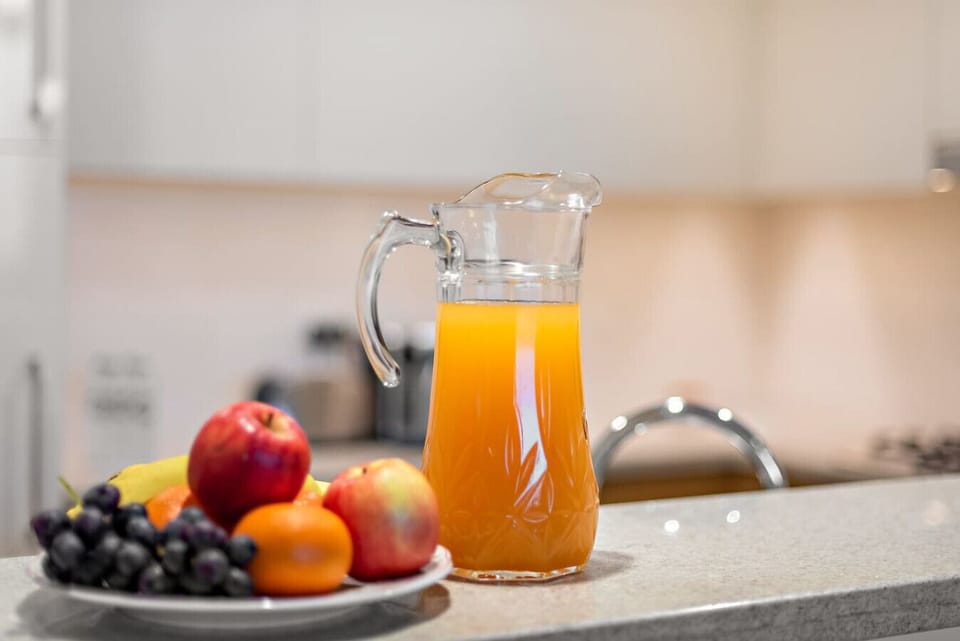 Kitchen Delight: Refreshing juice and fruit await your culinary adventures in this stylish kitchen!