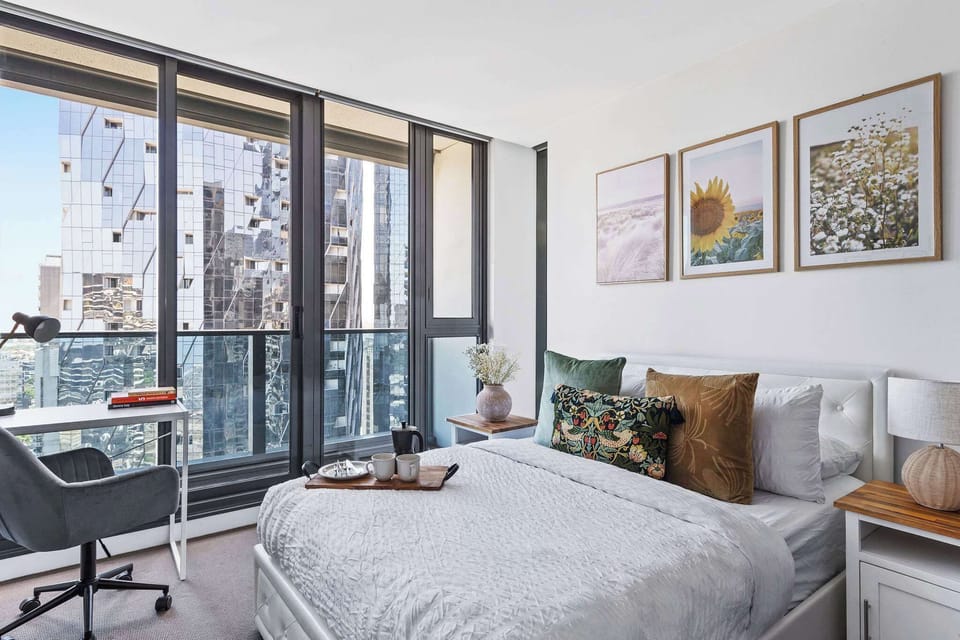 A second bedroom with a queen sized bed, study area & plush pillows.