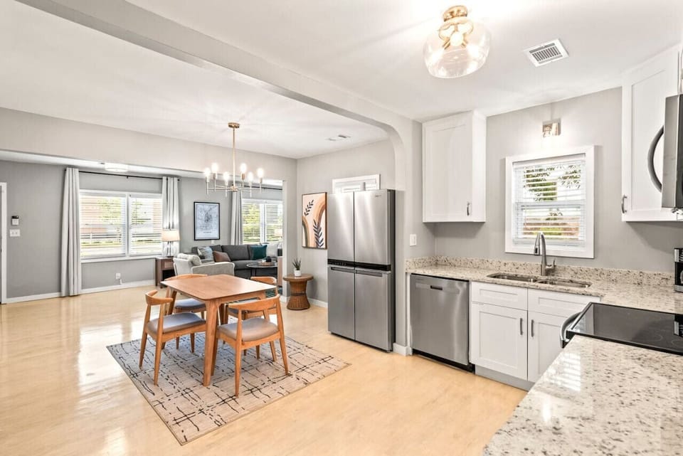 Our fully equipped kitchen with stainless steel appliances flows seamlessly into the dining and living areas, creating an open and inviting space. Perfect for cooking meals and enjoying time together with friends and family!