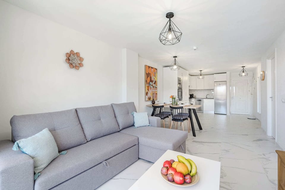 Living Room with TV, Sofa Bed, Dining Table, Coffee Table and Pool View