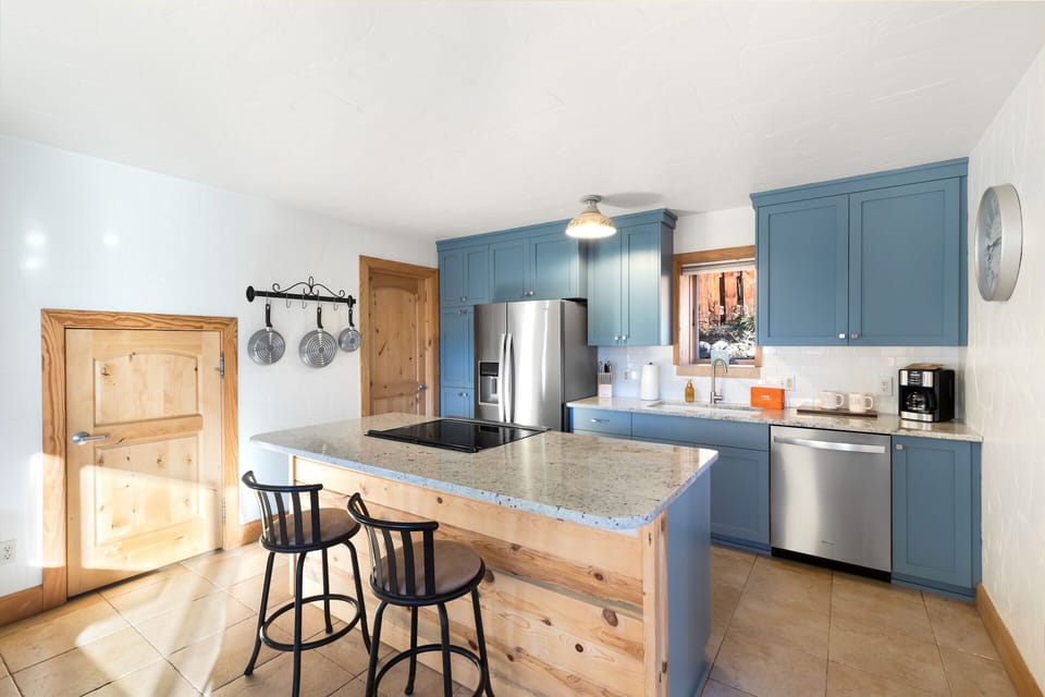 Fully equipped kitchen with stainless steel appliances and granite countertops.