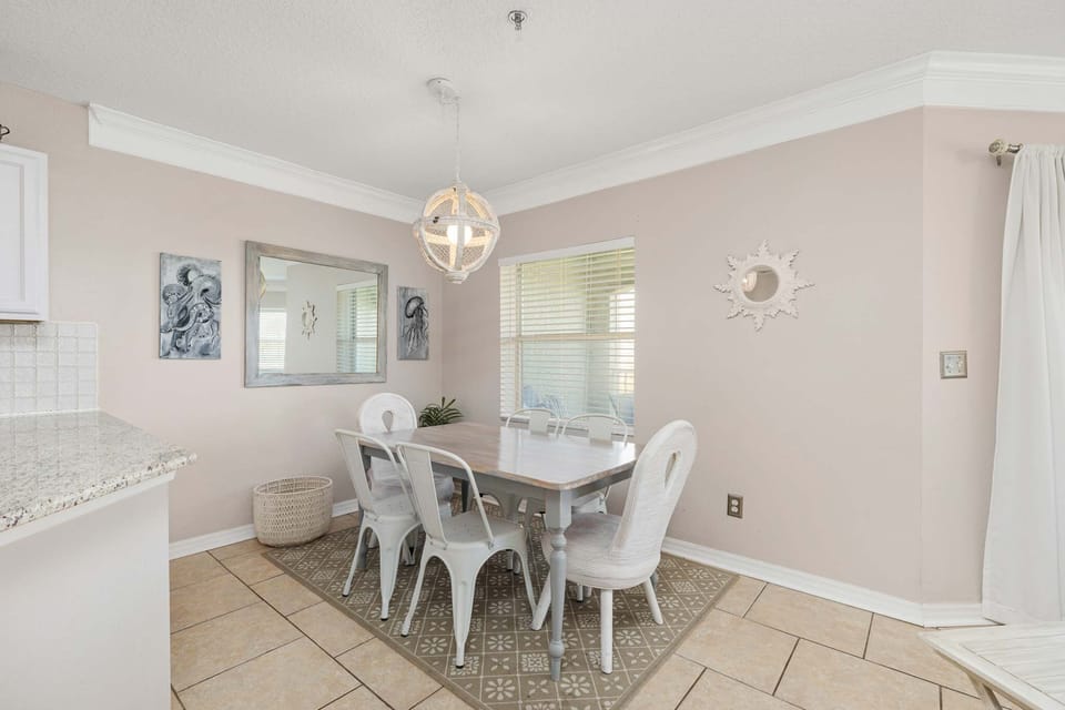 - Dining nook with natural light and modern wall art  
- Comfortable seating area perfect for shared meals  
- Open floor plan connecting kitchen and living space 