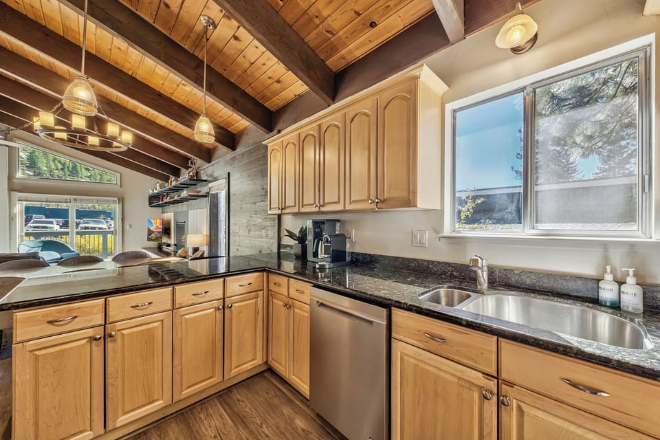 Your spacious kitchen features rich wood cabinets, granite counters, and stainless appliances under beautiful exposed beam ceilings.
