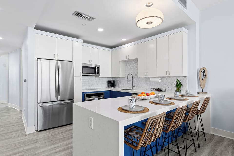 Sleek kitchen with stainless appliances and coastal style
