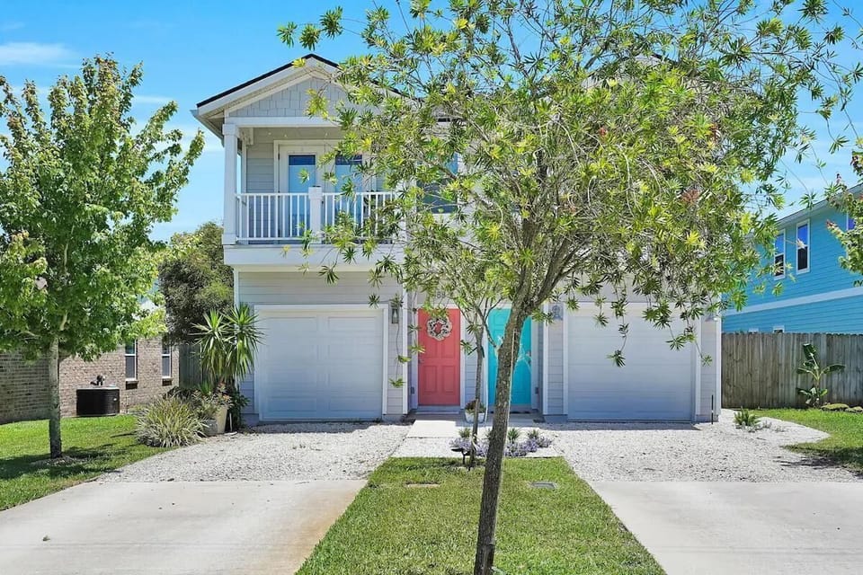 Exterior view of the whole house. Blue Door on the right leads into the house.