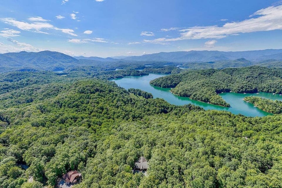 Aerial view of Lake Fontana surrounded by lush Smoky Mountain forest near Lookout Lodge.