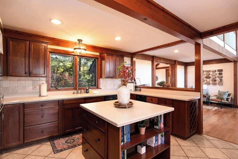 Spacious full kitchen with stainless appliances, wood cabinetry, and island at Lookout Lodge in Bryson City.