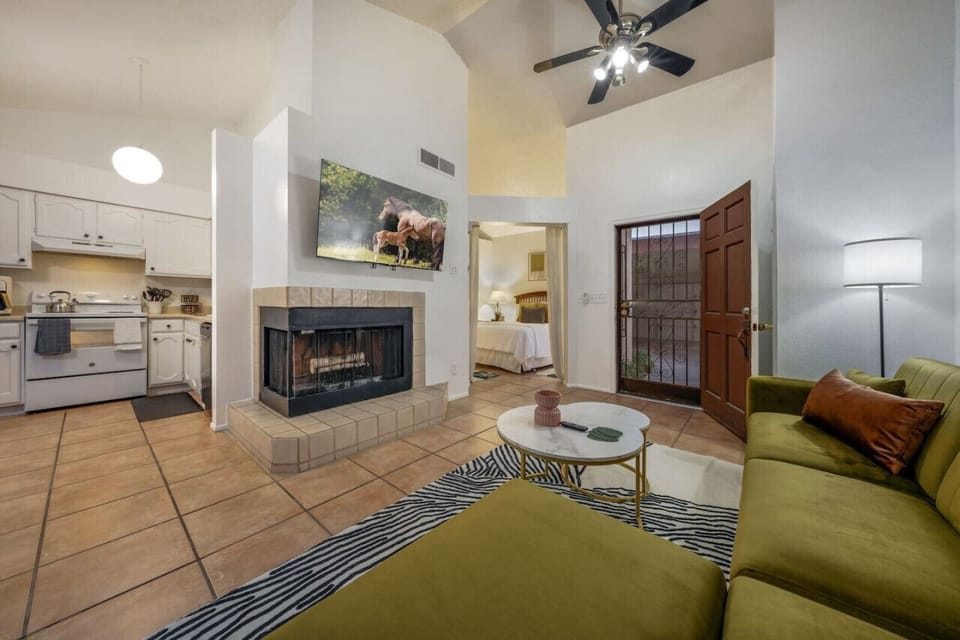 View of the kitchen, living room, and bedroom with queen bed and en-suite bathroom