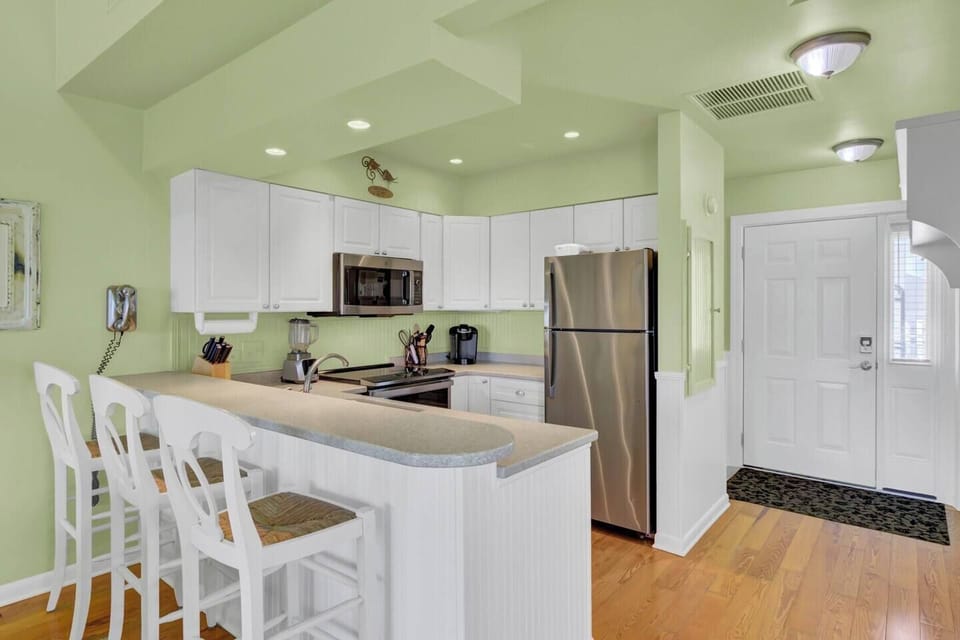 Enjoy an updated kitchen with new appliances, Corian countertops, and ample storage. Fully stocked with essentials, it offers plenty of space for meal prep and cooking-- everything you need for effortless, home-cooked meals during your stay.