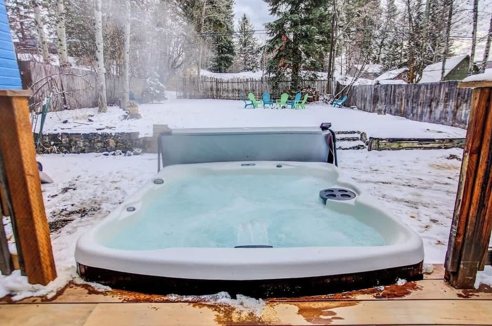 Steaming Hot Tub at 104 attached to New Brazilian Walnut Back Deck. Large Lawn, Horse Shoe Pit and Fire Ring in the Background