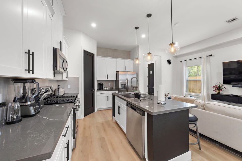 Fridge dispenses water and ice. Stainless steel appliances.