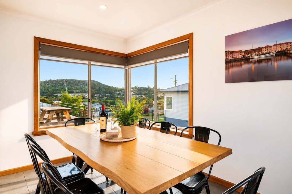Large dining table and open-plan kitchen create an easy space for family breakfasts, dinners and group gatherings.