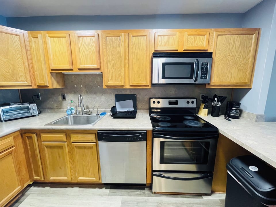 Designed for daily living, this kitchen offers a full-size fridge, range, spacious counters, and ample cabinets—everything you need, right where you need it.

