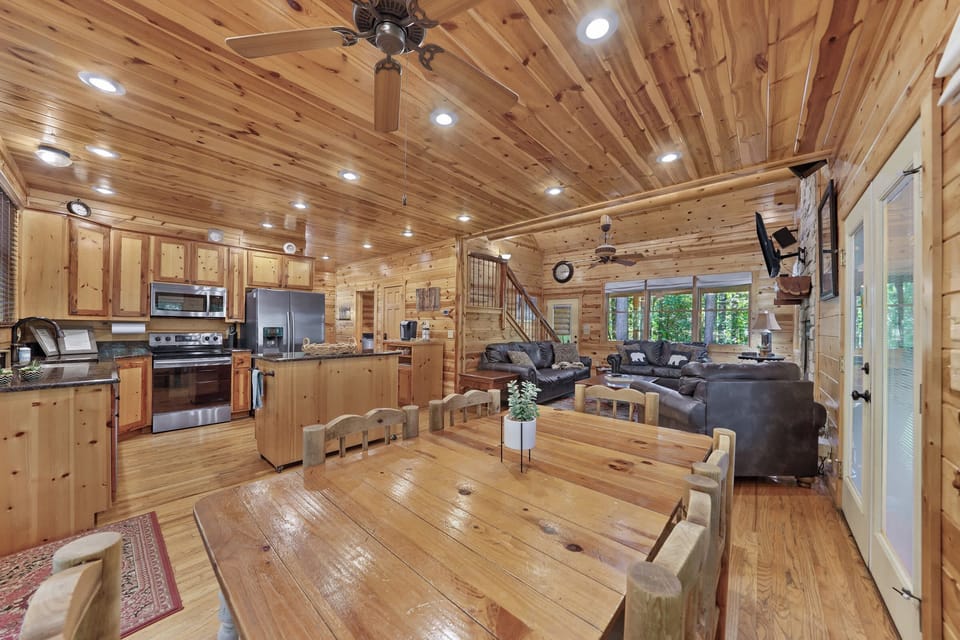 Gather around the rustic charm of the wooden dining table, perfect for shared meals and heartfelt conversations.