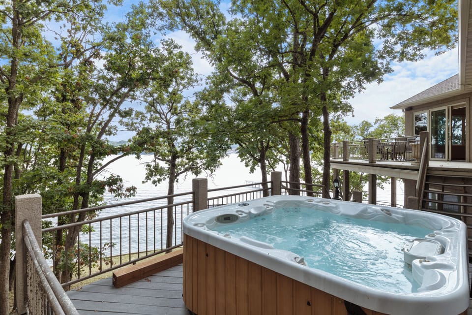Relax in a private hot tub surrounded by nature with stunning lake views.