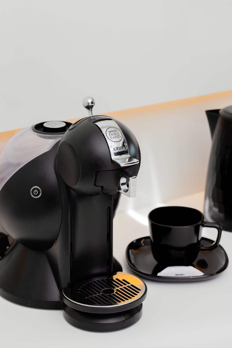 A minimal coffee corner with a black espresso machine. Compact and functional for daily use.