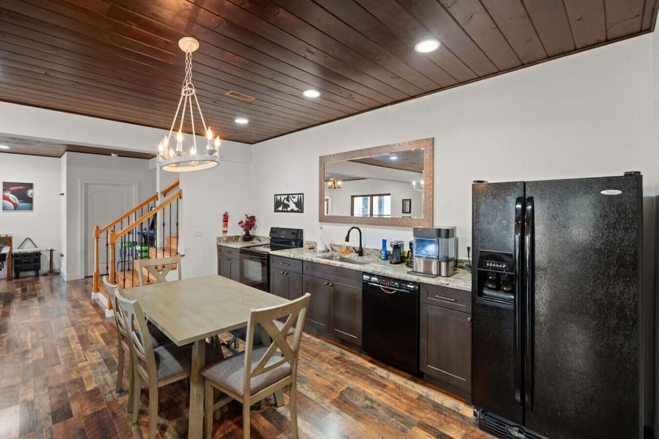 The downstairs area has a full kitchen space which includes a refrigerator, dishwasher, and oven. There is also a countertop ice maker provided.