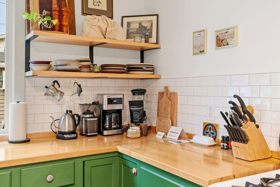 Your fully equipped kitchen awaits with quality appliances, ample counter space, and charming green cabinets perfect for preparing memorable meals during your stay.