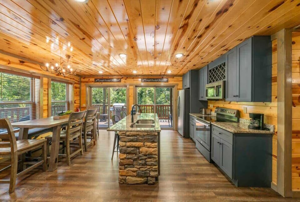 Enjoy a fully equipped kitchen stocked with all essentials for cooking and dining. The spacious layout includes a large dining table perfect for family meals. Modern appliances, ample counter space, and cabin charm make this the heart of your getaway