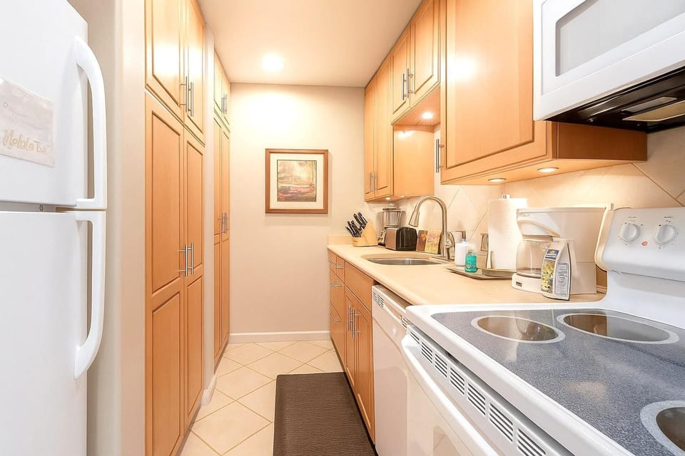 Whisk, stir, and sip your way through this cozy corridor of cabinets, where every drawer hides a dash of delight