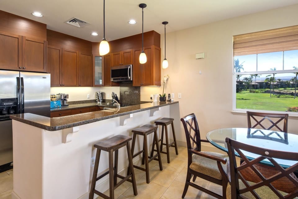 Modern island kitchen with open flow to the dining area and beautiful garden views 