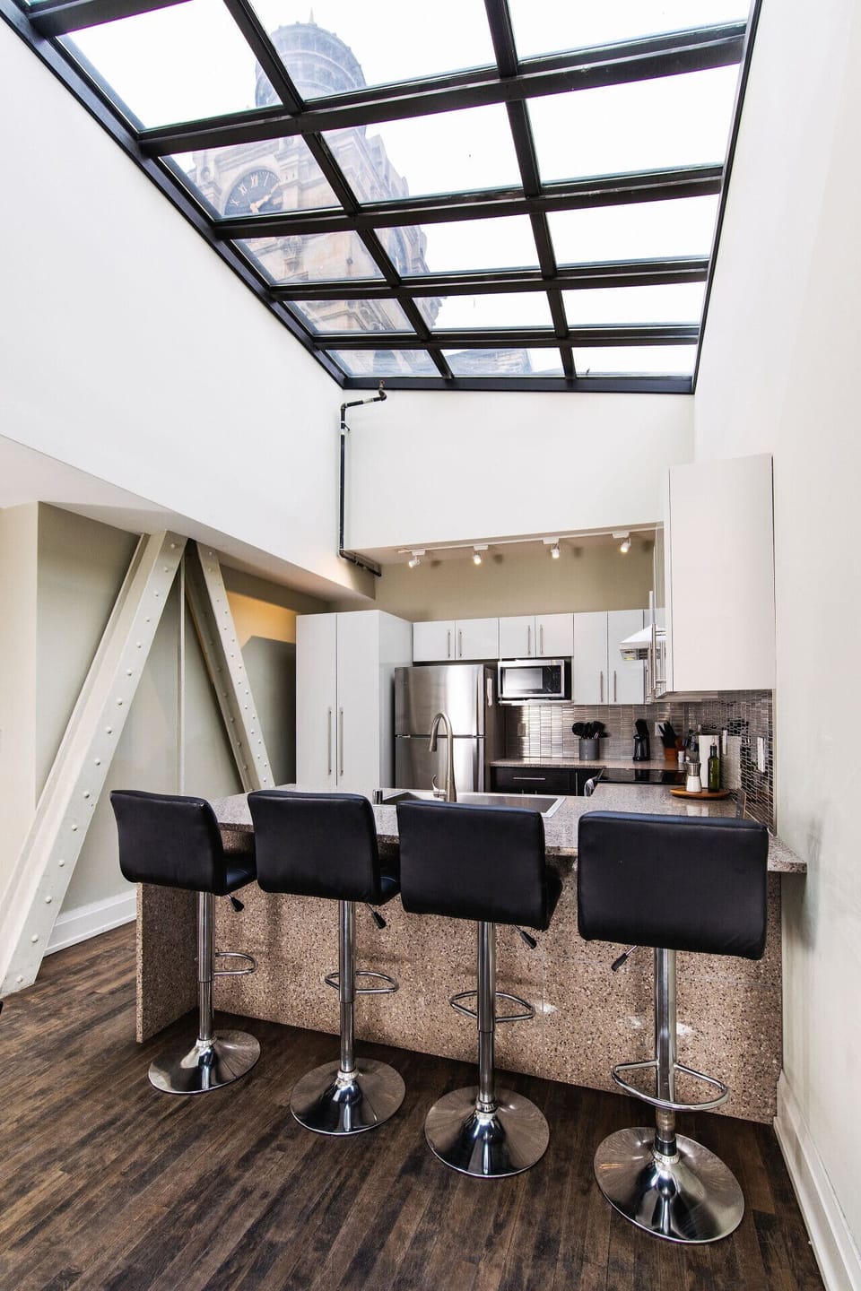 A dramatic skylight floods this penthouse with natural light, offering a unique perspective of the iconic clocktower above