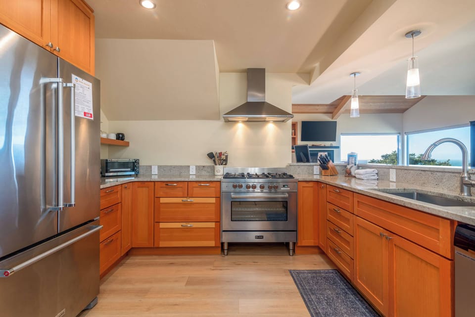 Full kitchen with kettle, coffee maker, toaster oven and more