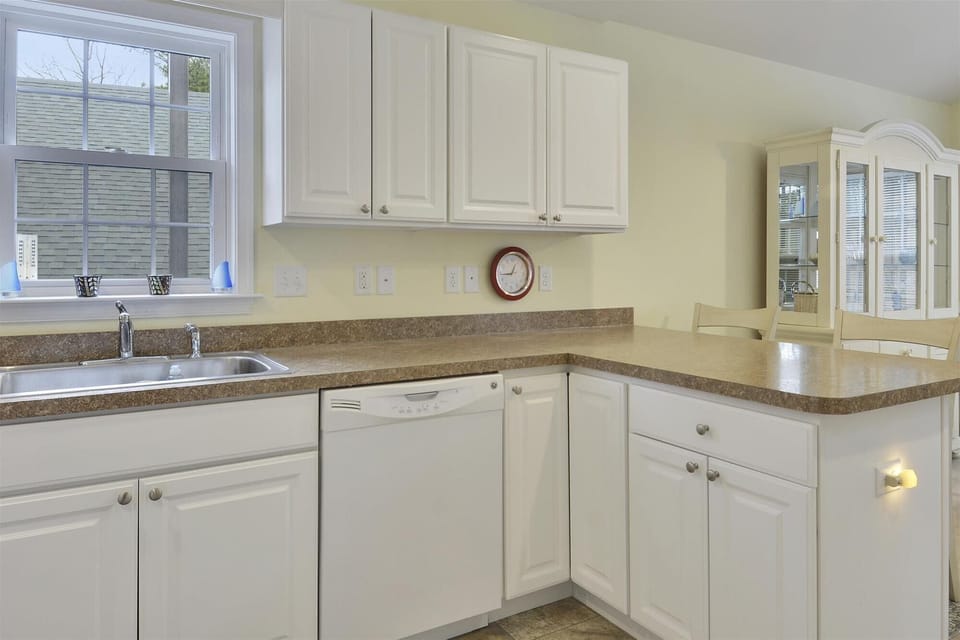 Your fully equipped kitchen features gleaming countertops, ample cabinet space, and natural light streaming through large windows, perfect for preparing meals during your stay.