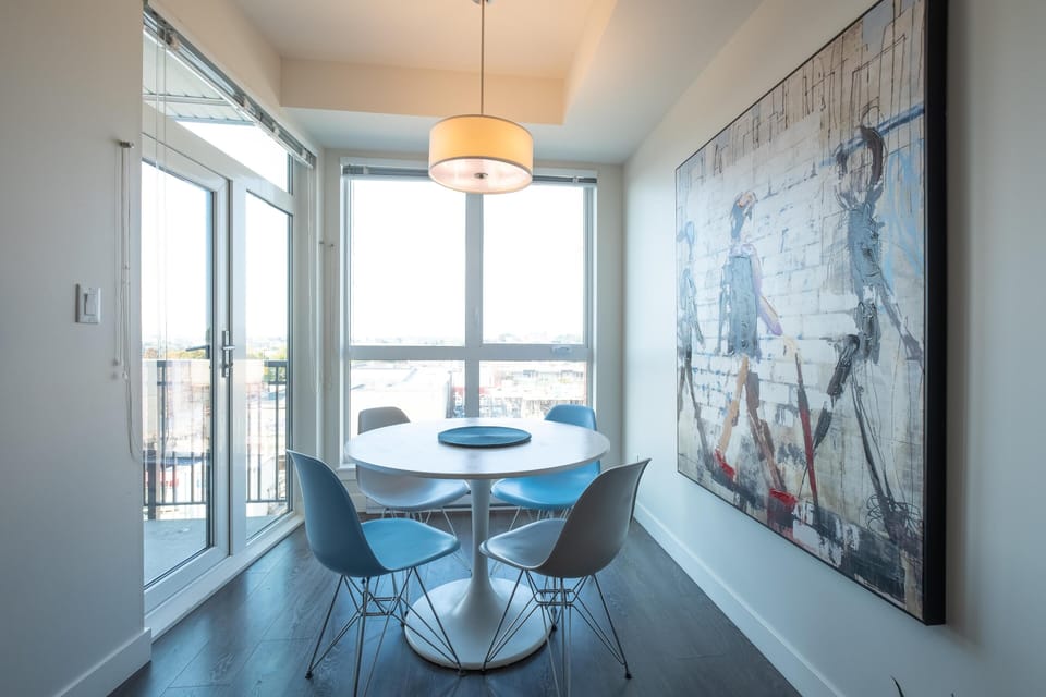 Dining for four with panoramic window views! Enjoy morning coffee or late-night dinners beside the glass patio doors.