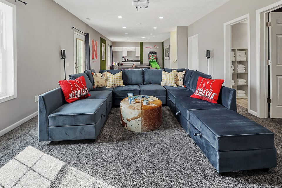 Game room with cozy lounge seating and carpeted flooring