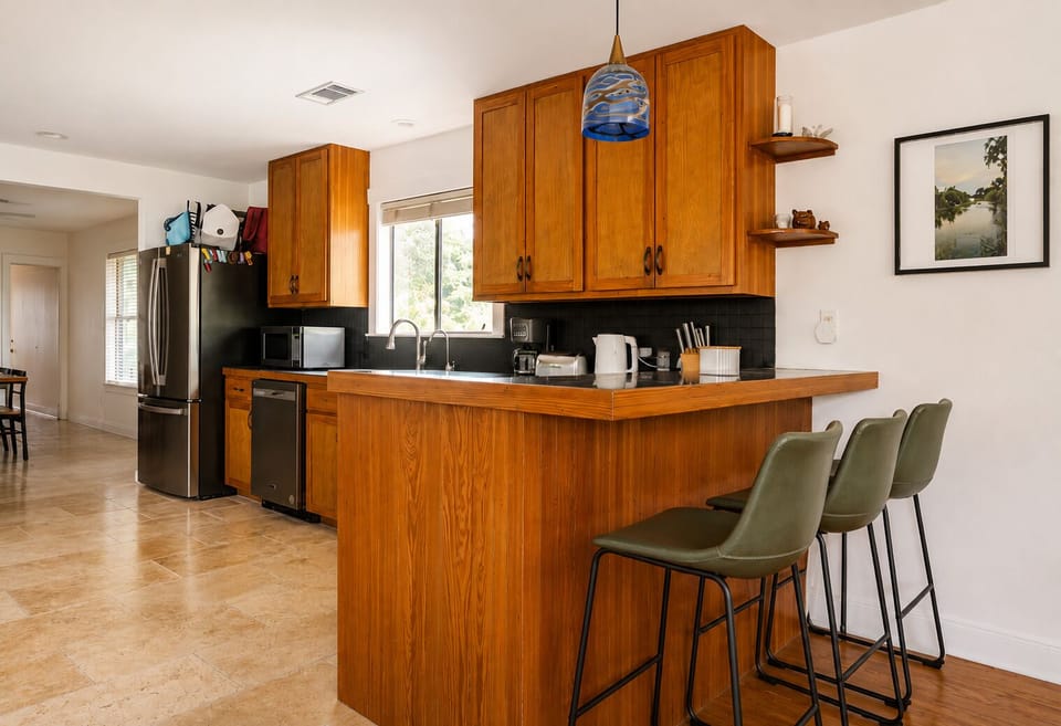 Warm wood kitchen with breakfast bar seating and stylish modern touches
