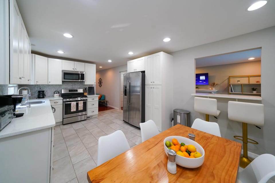 The kitchen has seating for 8 people. There is a table for 6 and 2 bar stools.