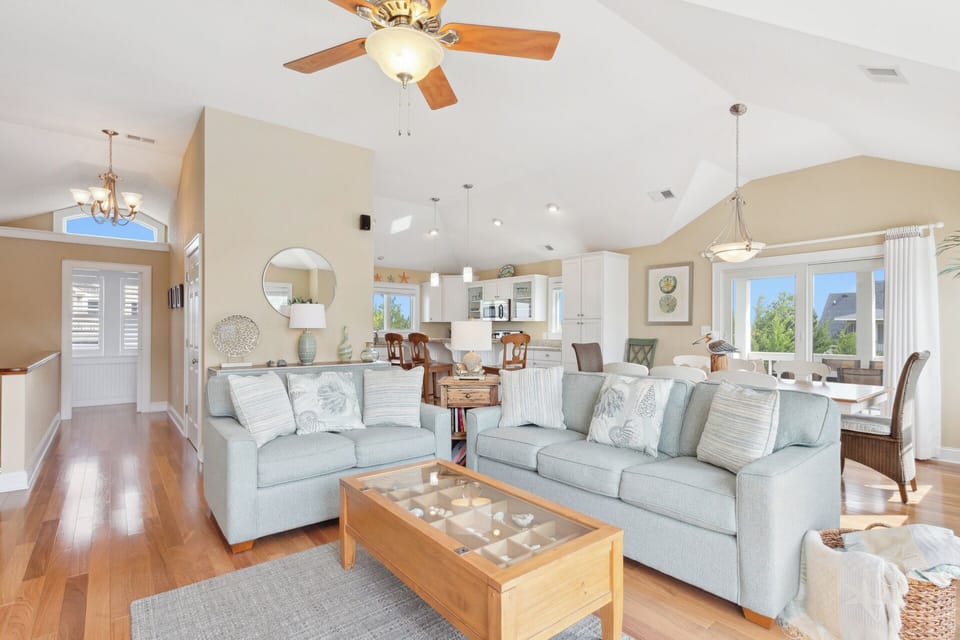 Your family will adore the Top-Level Living Area with bright cathedral ceilings, hardwood floors, and bountiful natural lighting coming in through the walls of windows.