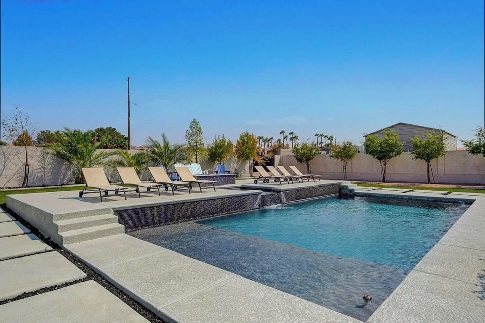 Waterfall pool, hottub, firepit, adorandak glider, and chairs 
