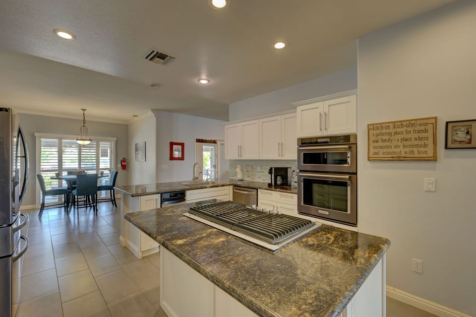 Full size kitchen full of amenities and a breakfast table 
