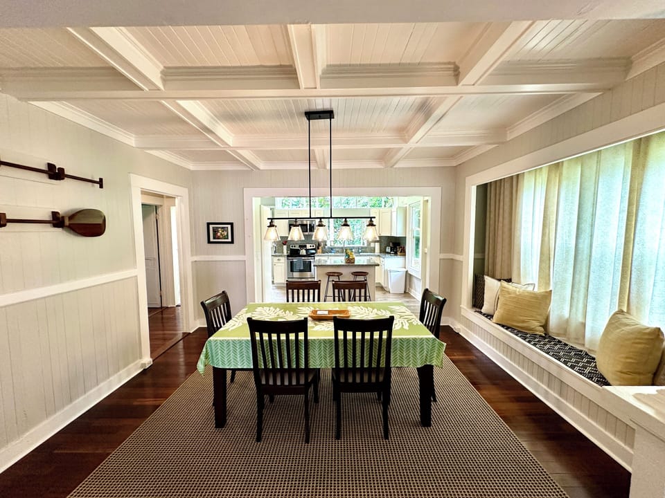 The dining room with its oversized window seat with a view of the fish pond.