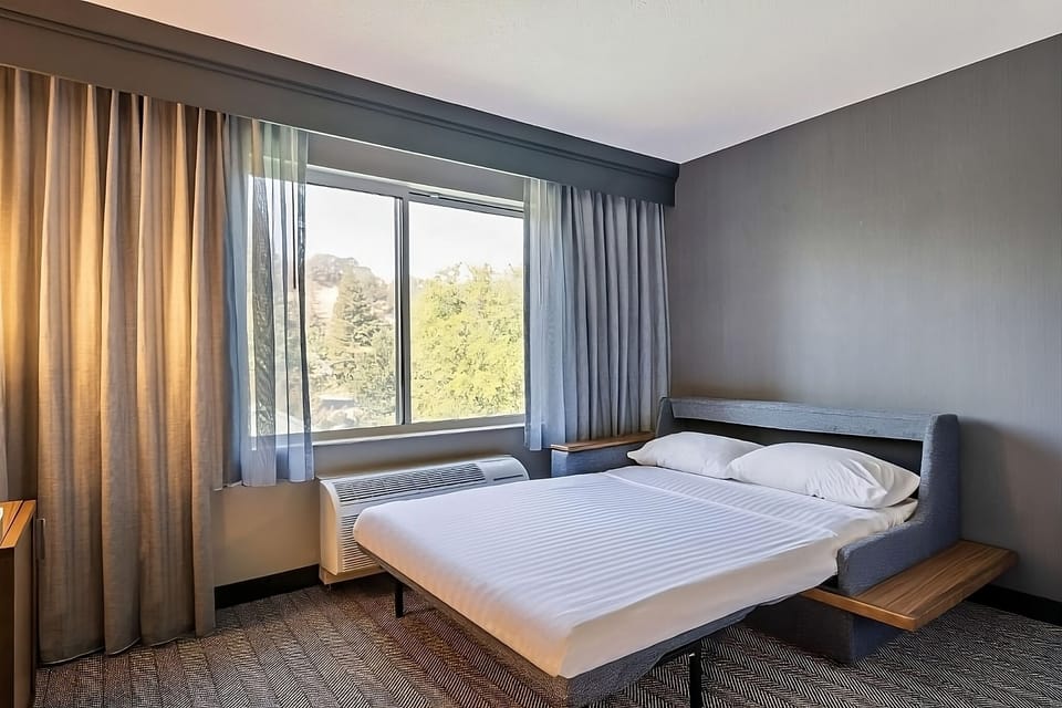 Unwind in a sunlit king bed with calming views.
