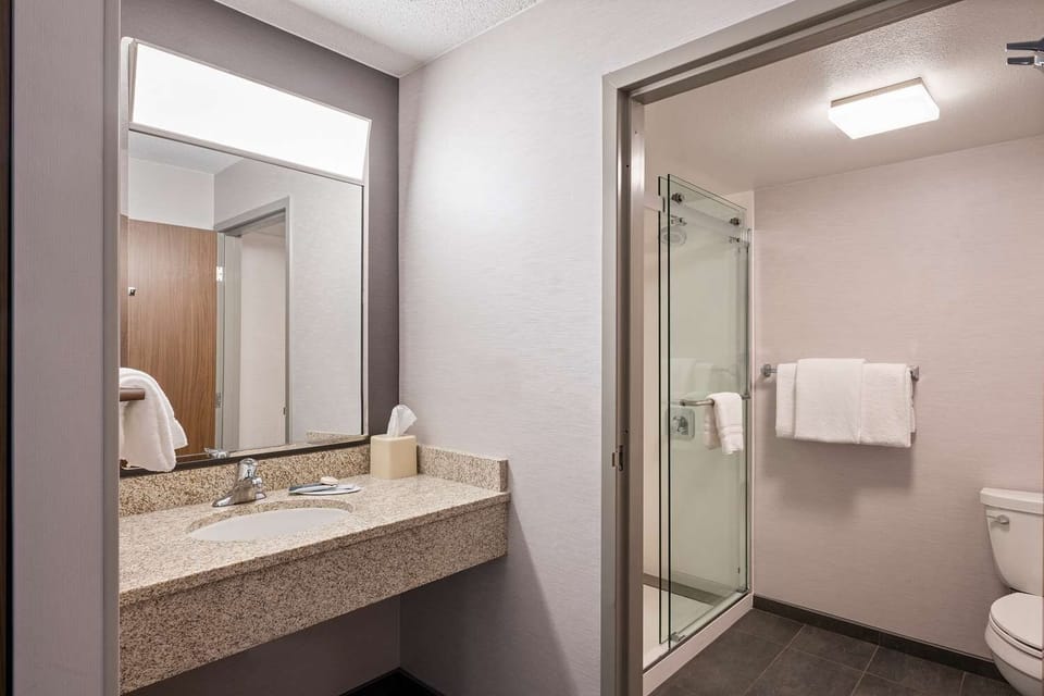 Refresh comfortably in a bright bath with glass shower.