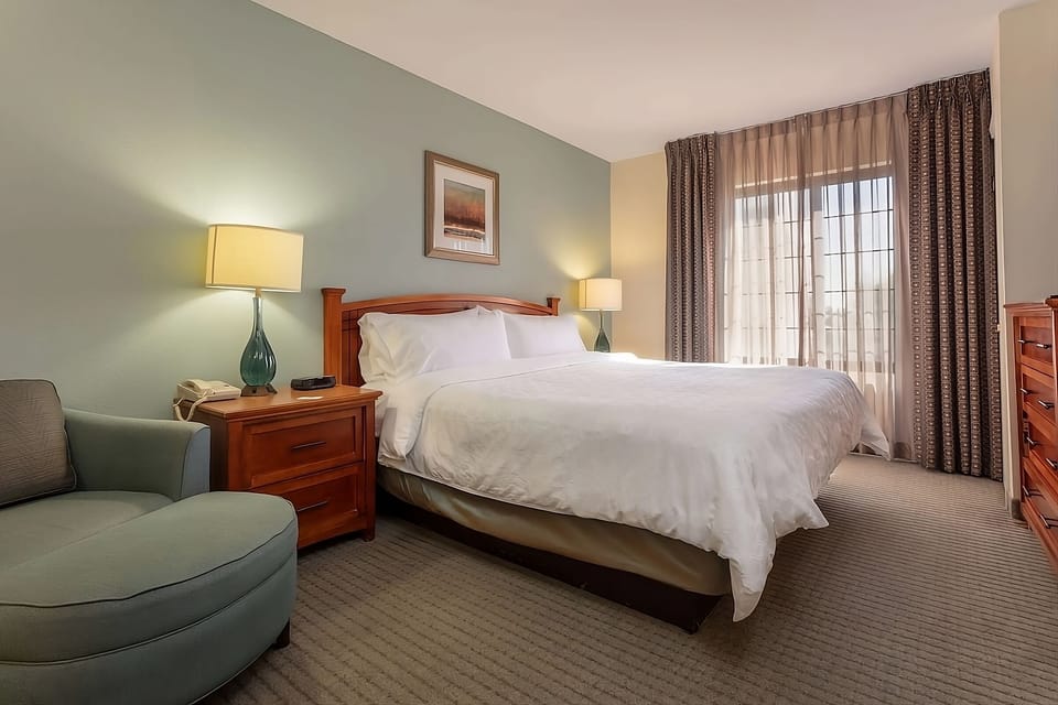 Drift off in a quiet king room with cozy seating.
