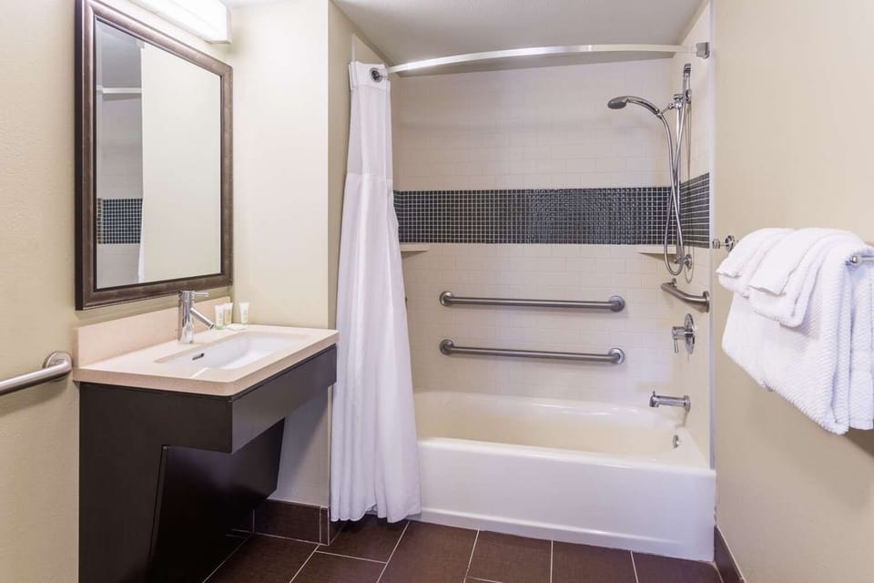Refresh in a clean, accessible tub-shower with bright vanity.